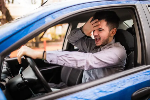 frustrated man driving car min